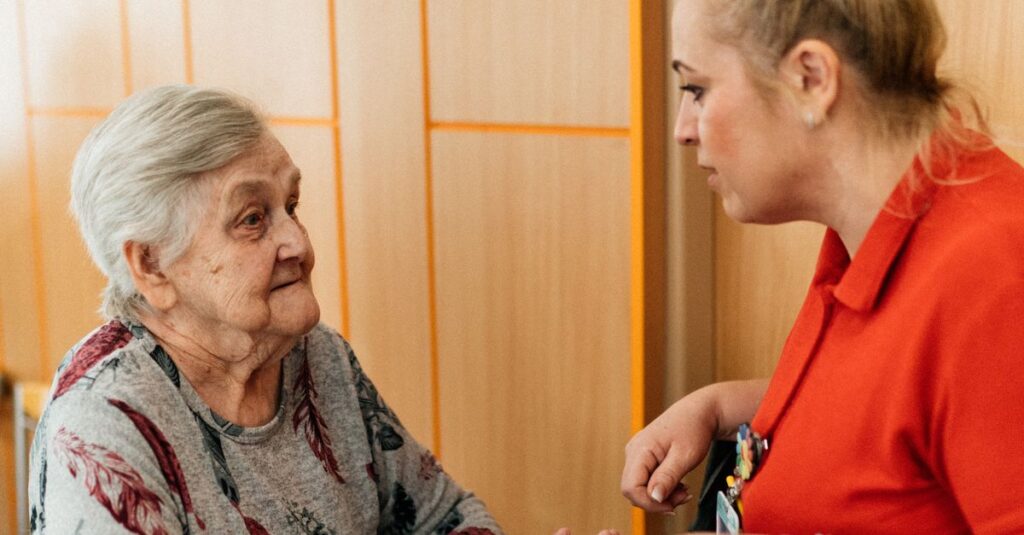 A caregiver assists an elderly woman in a retirement home corridor, fostering companionship and support.