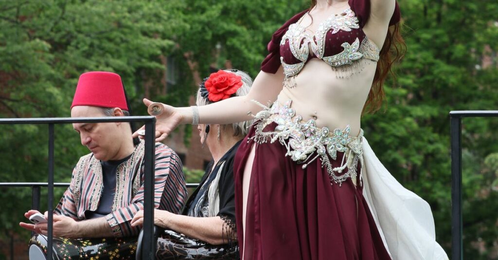 A vibrant dance performance captured during a lively parade in New York.