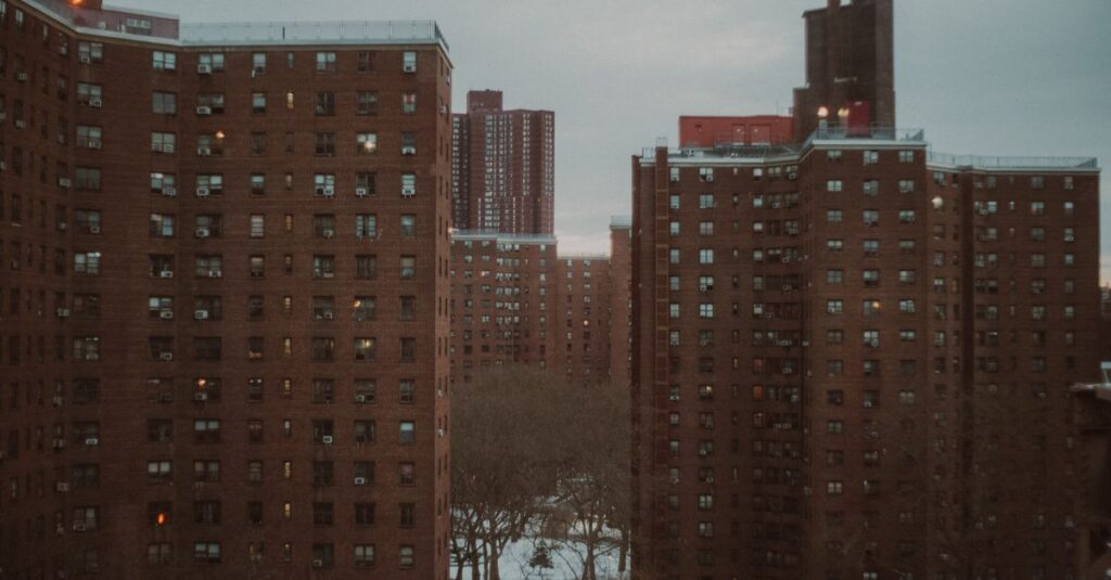 Urban New York City apartment buildings at dusk, showcasing winter ambiance.