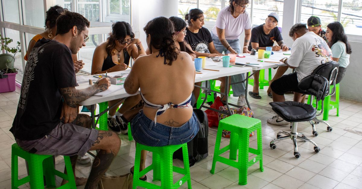 Group of adults engaged in a creative workshop indoors in Acapulco, Mexico.