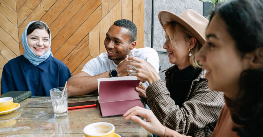 A group of friends sharing a joyful moment over coffee inside a cozy cafe.