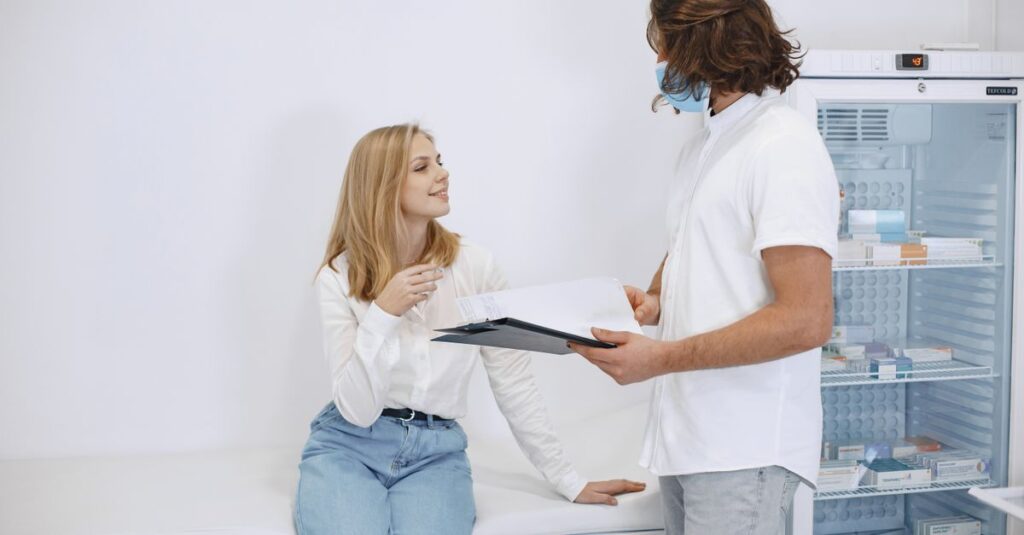 A healthcare professional consulting with a patient in a modern examination room.