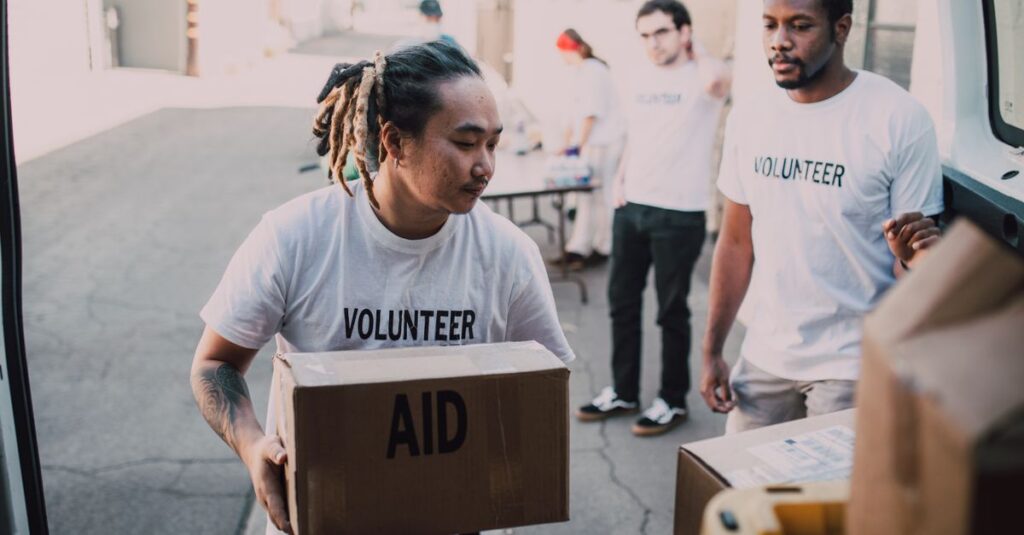 Volunteers unload aid supplies from a van, showcasing teamwork and community support.