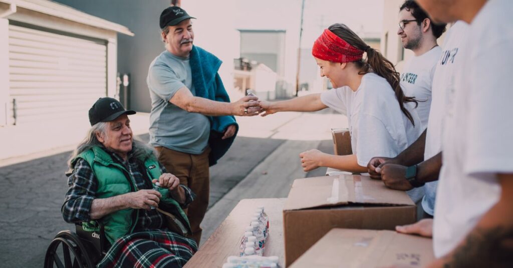 Volunteers distribute water and supplies to people outdoors, promoting community support and kindness.