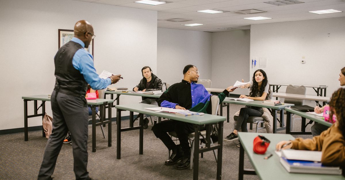 University classroom with students receiving instructions from a professor.