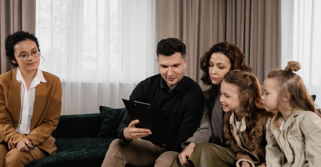A family receiving advice from a professional advisor indoors, focused on financial planning.