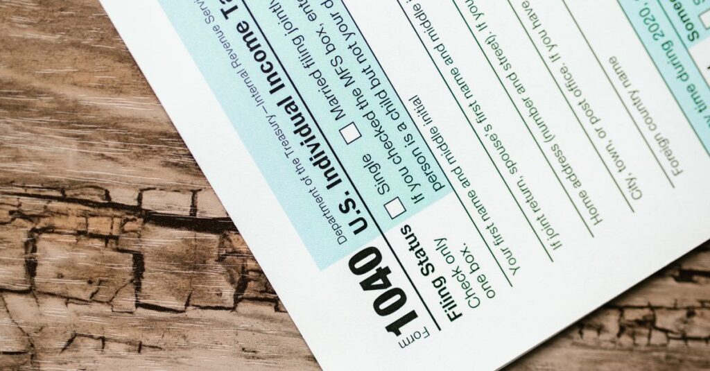 A close-up view of a 1040 US Individual Income Tax Return form on a wooden surface.