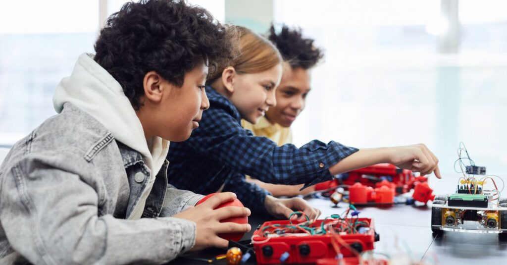 Children working on a robotics project in a classroom setting, exploring technology and creativity.