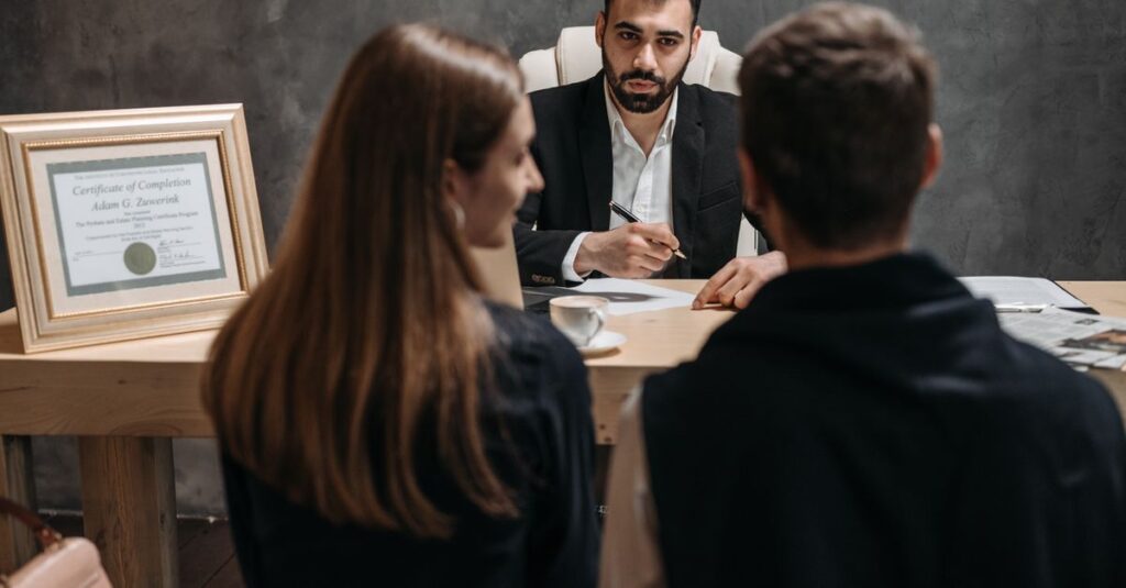 A business meeting with a professional advisor discussing documents in an office.
