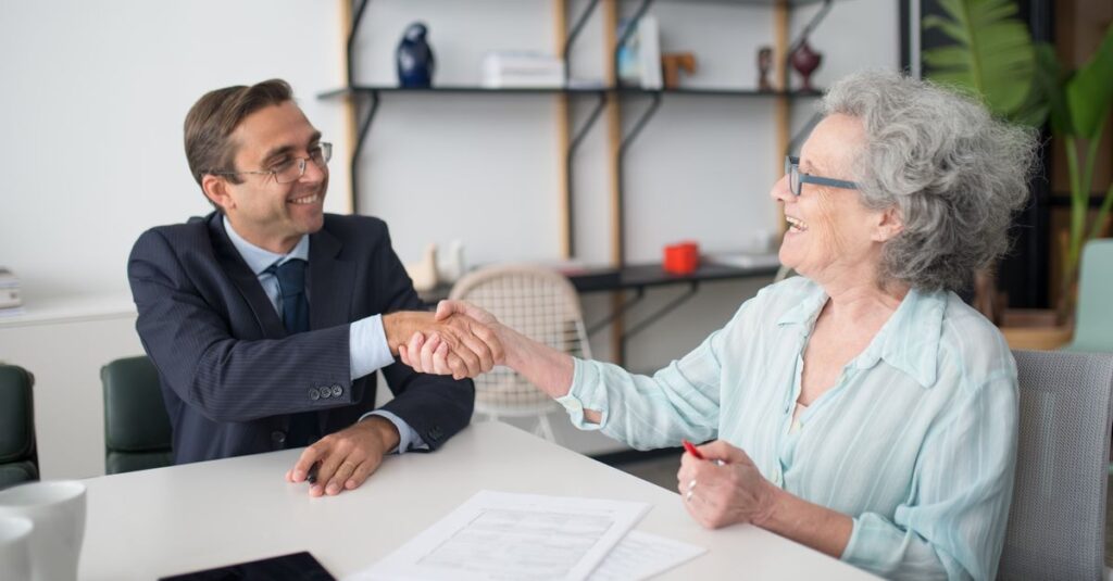 Professional business meeting with a handshake between consultant and client at an office.