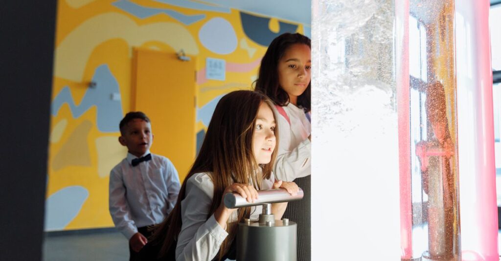 Children engage in a science experiment with colored liquids at school.
